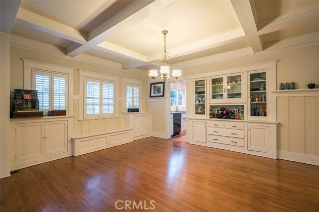 Dining room with built-in showcase cabinetry, built-in bench seating to add extra dining space for the party, The owners envisioned moving the built-in to the wall on the right and opening the kitchen to the dining area.