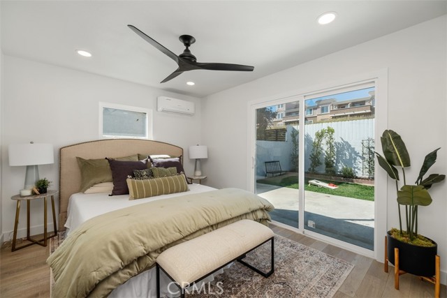 The master bedroom with a sliding glass door out to the backyard.