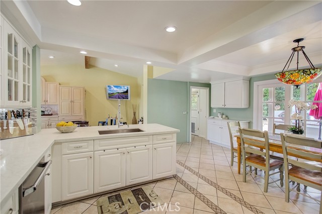 View of laundry room/garage entrance in the background and straight out your french sliders, you'll find outdoor kitchen and pizza oven!
