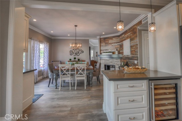 Looking from the kitchen into the dining room.  Great pendant lighting over the prep area and wine fridge.