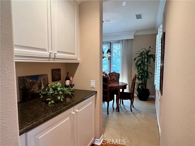 dry bar in between kitchen and dining room