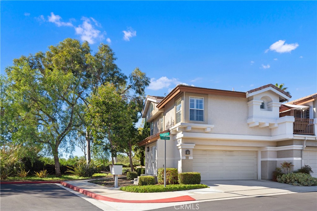 This private, end location, cul-de-sac home has beautiful views of the hills and city lights. It is located within the peaceful, gated community of Mirasol.  Offering 3 bedrooms, 2.5 baths, this spacious floor plan provides a “great room” feel with the living room opening to the dining and kitchen areas, perfect for the gatherings of family and friends to enjoy an evening of board games! Newer sliding doors open to the expansive, private patio with patio cover and built-in barbecue area; relax this summer outside enjoying the quiet, the views, and great company! This open floor plan is light and bright, with great window patterns cascading light into the home. It is beautifully appointed with wood flooring and 5” baseboards throughout the downstairs, a wood burning fireplace with custom tile and mantel in the living room, designer paint colors, plantation shutters and ceiling fans throughout. The kitchen is spacious, nicely improved with recessed can lights, upgraded stainless steel appliances and kitchen faucet; enjoy an abundance of countertop space and cabinetry! The wonderful upstairs master bedroom is situated toward the view with a delightful sitting area.  An added plus is the walk-in closet! The adjoining bathroom has dual sinks, a separate tub and shower, new lighting fixtures and mirrors, and upgraded tile flooring. The secondary bedrooms are spacious, one with a volume ceiling, both light and bright. The secondary upstairs bathroom has upgraded tile flooring and new glass doors for the tub/shower enclosure. The two-car attached garage has ceiling mounted storage racks. The furnace was replaced in 2020 and this home has been partially re-piped with PEX piping. Ready for summer? You have Lake Mission Viejo privileges and are beach close! Terrific proximity to everything - schools, shopping, dining, parks, and recreational areas, you won’t lack fun things to do. Also, easy access to the freeway and toll roads. Race to this one. You will be glad you did!