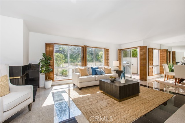 Open concept living room opens to dining area and back yard