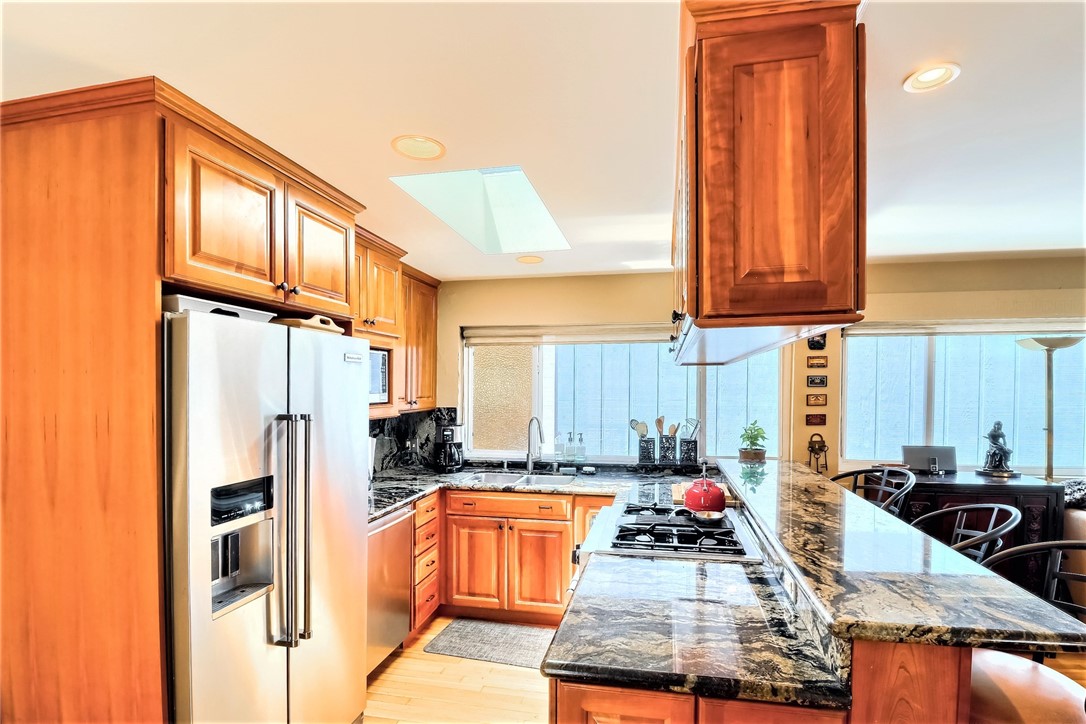There are Abundant Storage Cabinets, a Quality Refrigerator, Large Sink and Bright Windows.