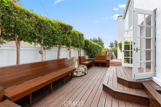 BACKYARD AREA WITH CUSTOM BENCHES, DECKING AND STONE FIREPLACE