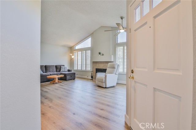 Main living room and dining area with LVP floors, vaulted ceilings, clerestory windows, lots of light