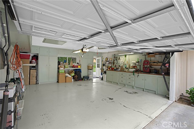 the spacious garage offers plenty of storage and a workbench.