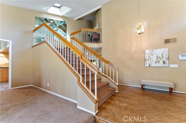 This kitchen is for those that like to entertain. So much space to enjoy and cabinets to store. Granite counters, built in chairs at island, double oven, stove cook top, double pane windows, skylight, second sink, tile flooring. Built in refrigerator, ceiling fan, microwave, dishwasher. Through way in the image leads to the formal dining/living.