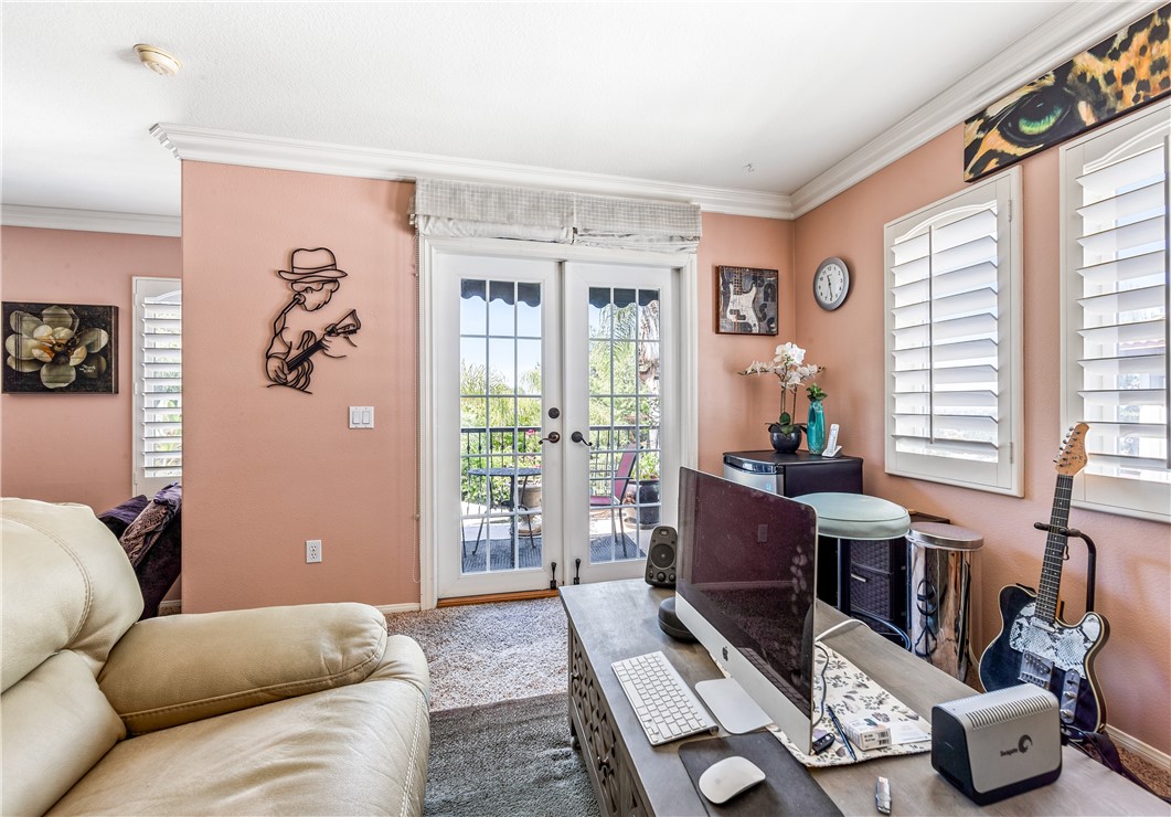 Primary bedroom sitting room with patio overlooking the city lights