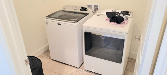 Inside home laundry room. Washer & dryer included.