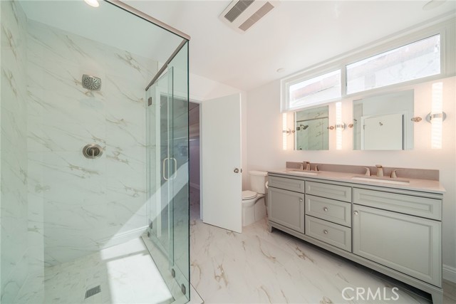 Primary bathroom with shower and dual sink countertop