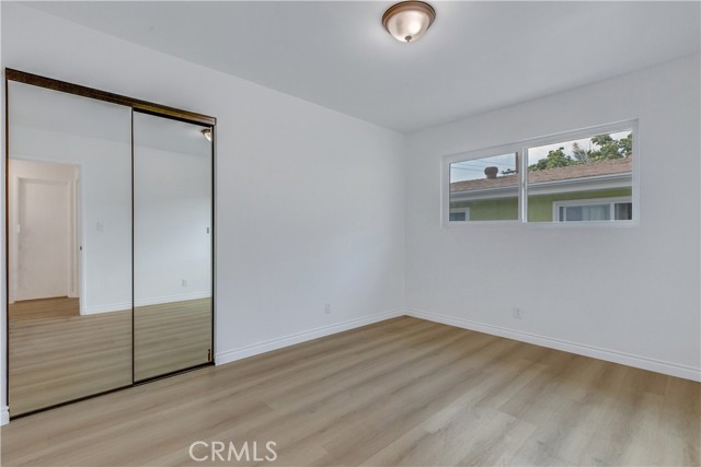 Bedroom 2. New Energy Efficient Dual Pane Windows / New Mirror Closet Sliding Doors / New Laminate Flooring.