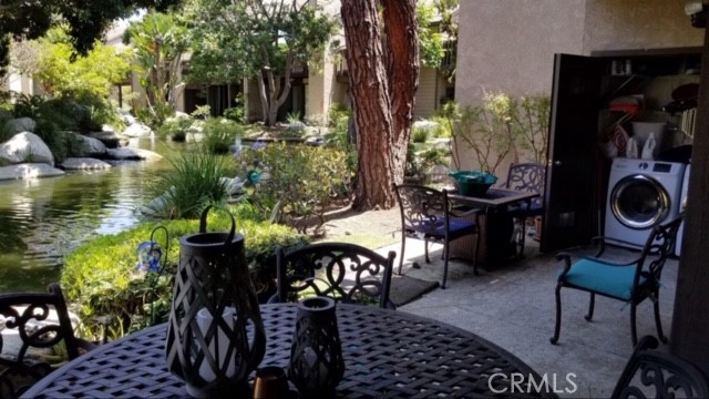 2534 W Macarthur Boulevard Santa Ana, California GROUND FLOOR CONDO has an OPEN FLOOR PLAN for easy family living and entertaining featuring a spacious living room with high ceilings, fireplace and glass sliding doors that open to the large, private back patio with the VIEWS and sounds of nature. MASTER BEDROOM SUITE has two large closets, attached bathroom plus access to the rear patio with private laundry closet, This extensively landscaped gated community has running Streams, Waterfalls, Ponds, Flowers, Plants, Trees and Peaceful Views. WOODLAKE is located in the trendy Cosmopolitan area of SOUTH COAST METRO and SOUTH COAST PLAZA and some of OC's finest shops, restaurants and entertainment.
