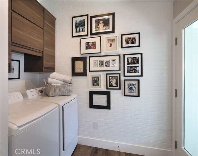 Laundry area and rear door to carport and artists studio.