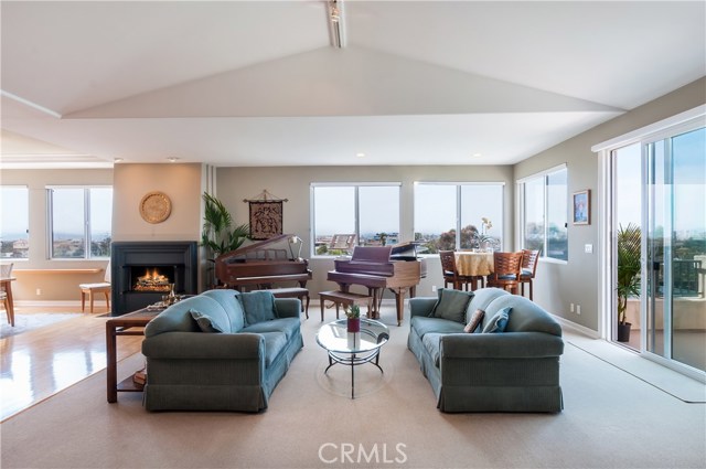 Formal Living Room offers multiple seating and furniture grouping options.  Step through glass doors to enjoy al fresco dining on your ocean view deck.