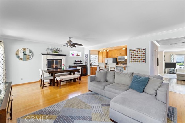 Family room has hardwood floors, brick fireplace and opens to backyard and patio/pool/spa.