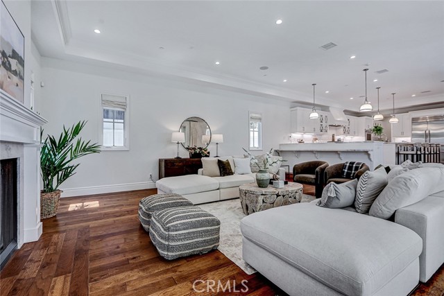 Family Room Area with Limestone Fireplace and View to Kitchen Area