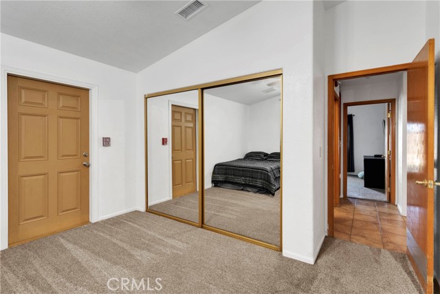 Guest Bedroom 1 with door leading to side yard.