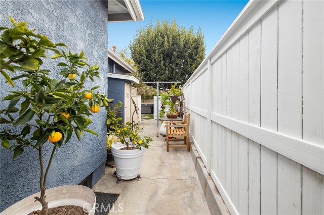 There are the lemons in their pots and the newer fence with two outdoor showers for summer fun. Spacious areas on each side of the home.