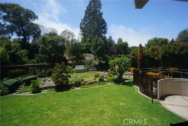 Back yard from living room windows. Property line ends behind little garden house.