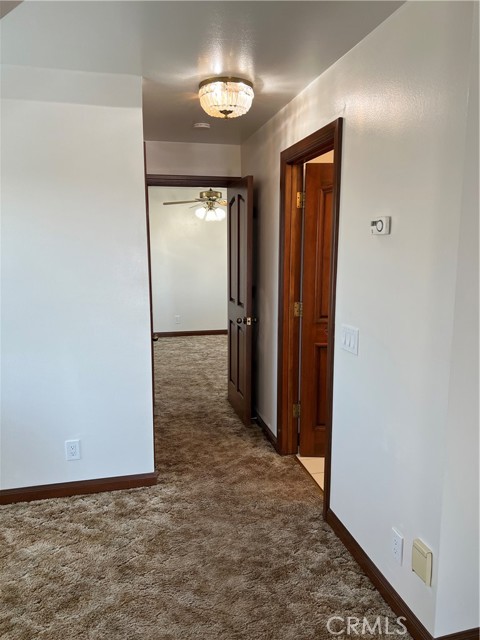 Upper level hallway leading to a 3/4 bath and bedroom #5