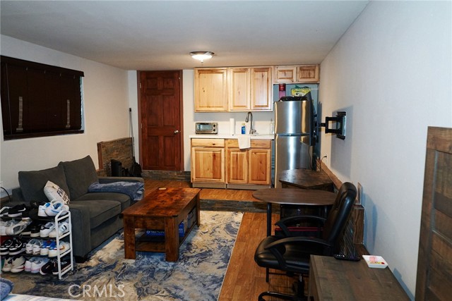 Downstairs bedroom with kitchen + living space