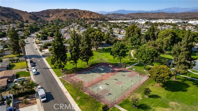 Westmont Park with tennis courts, basketball courts, baseball diamond, playground, and grassy fields across the street