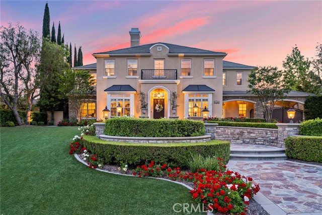 Experience the ultimate custom-caliber French-inspired estate behind the prestigious entry gates of Yorba Linda’s exclusive Manor House enclave. Embraced by a very private, flat one-acre home site, the residence exhibits exquisite curb appeal with impeccably maintained formal front-yard landscaping, custom hardscape and a long driveway leading to a gated motor court. Elegant Maison de Maître architecture, distinguished by its classic symmetrical facade and flawlessly maintained interior draws the eye to a formal entrance that leads to a towering foyer with curving staircase. Columns frame passageways to formal living and dining rooms with a Butler's pantry that sets the scene for extravagant entertaining. Casual affairs are equally accommodated in a massive Great Room with 2 story ceilings and custom window that looks out on the resort-style backyard.  An adjacent library/game room with dry bar shares a flow through fireplace. The towering ceilings and dramatic 13' window lends abundant natural light and open ambiance to the Great Room, which flows seamlessly to a custom gourmet kitchen including a breakfast room, 11' island with seating, a brick accent wall, copper sink, and newer Sub-Zero and Thermador appliances. At approximately 5,700 square feet, the expansive home presents six en-suite bedrooms and six and one-half baths, including a main-level guest suite and a detached one-bedroom casita with spacious view deck above the garage. A bonus room is located upstairs and makes a great office or playroom. The grand primary suite hosts a fireplace, walk-in closet with furniture-quality built-ins and a luxurious en-suite bath with jetted tub and dual vanities. Enjoy gleaming hardwood flooring throughout, custom built-ins, newer HVAC, newer window coverings, four garages with EV charger, and an owned 36-panel ground-mounted solar power array. Enjoy a spectacular and inspiring outdoor entertaining oasis like you've never seen before! Lifelike turf graces the front yard, and the private backyard rivals lux resorts with a saltwater pool and spa, putting green, a massive lawn for parties, a heated cabana with TV, an outdoor kitchen, built-in BBQ and a custom stone fireplace. Simply a spectacular estate for discerning buyers looking for only the finest in luxury living and lifestyle. Manor House is convenient to top schools, including Yorba Linda High School, as well as shopping centers, recreation, the Yorba Linda Country Club, and major freeways.