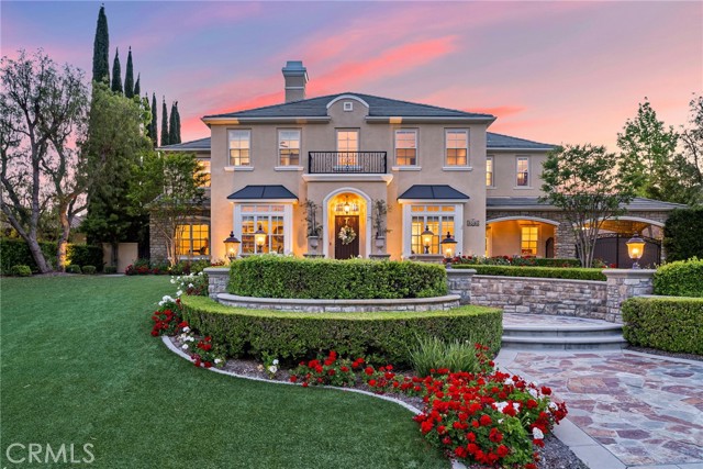 Experience the ultimate custom-caliber French-inspired estate behind the prestigious entry gates of Yorba Linda’s exclusive Manor House enclave. Embraced by a very private, flat one-acre home site, the residence exhibits exquisite curb appeal with impeccably maintained formal front-yard landscaping, custom hardscape and a long driveway leading to a gated motor court. Elegant Maison de Maître architecture, distinguished by its classic symmetrical facade and flawlessly maintained interior draws the eye to a formal entrance that leads to a towering foyer with curving staircase. Columns frame passageways to formal living and dining rooms with a Butler's pantry that sets the scene for extravagant entertaining. Casual affairs are equally accommodated in a massive Great Room with 2 story ceilings and custom window that looks out on the resort-style backyard.  An adjacent library/game room with dry bar shares a flow through fireplace. The towering ceilings and dramatic 13' window lends abundant natural light and open ambiance to the Great Room, which flows seamlessly to a custom gourmet kitchen including a breakfast room, 11' island with seating, a brick accent wall, copper sink, and newer Sub-Zero and Thermador appliances. At approximately 5,700 square feet, the expansive home presents six en-suite bedrooms and six and one-half baths, including a main-level guest suite and a detached one-bedroom casita with spacious view deck above the garage. A bonus room is located upstairs and makes a great office or playroom. The grand primary suite hosts a fireplace, walk-in closet with furniture-quality built-ins and a luxurious en-suite bath with jetted tub and dual vanities. Enjoy gleaming hardwood flooring throughout, custom built-ins, newer HVAC, newer window coverings, four garages with EV charger, and an owned 36-panel ground-mounted solar power array. Enjoy a spectacular and inspiring outdoor entertaining oasis like you've never seen before! Lifelike turf graces the front yard, and the private backyard rivals lux resorts with a saltwater pool and spa, putting green, a massive lawn for parties, a heated cabana with TV, an outdoor kitchen, built-in BBQ and a custom stone fireplace. Simply a spectacular estate for discerning buyers looking for only the finest in luxury living and lifestyle. Manor House is convenient to top schools, including Yorba Linda High School, as well as shopping centers, recreation, the Yorba Linda Country Club, and major freeways.