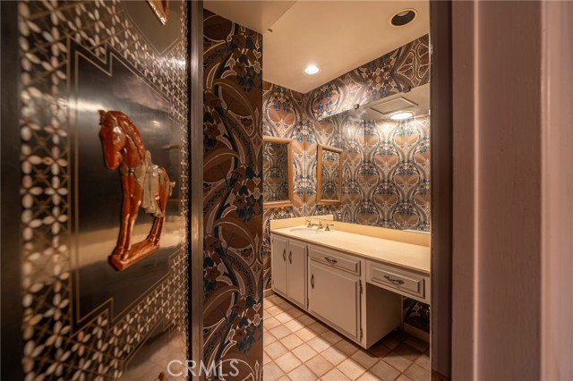 Powder room off of the library and kitchen