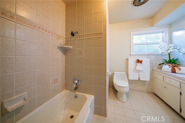 Hallway bathroom with tub and shower.