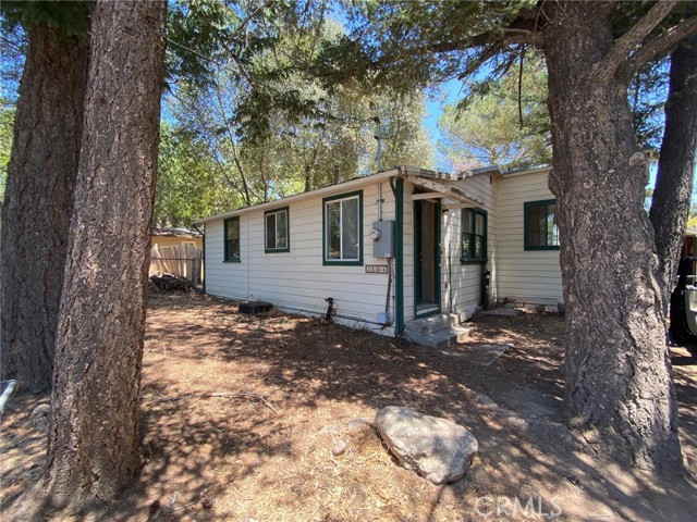 3594 Halika Street Clearlake, California Investor Special! 2 bed / 1.5 bath home has so much potential! Tree studded and fully fenced DOUBLE parcel includes a large detached garage with laundry hook ups. Inside find a formal entry, spacious living room, retro kitchen with electric range, dishwasher & refrigerator. Cozy dining area off the kitchen has a new sliding glass door that leads to the covered deck & expansive backyard. 2 comfortably sized bedrooms with nice sized closets. Master bedroom has an ensuite bath that has been gutted and is ready to be remodeled. Guest bath includes a pedestal sink and stall tub/shower combo. Ideally located near town with the elementary school just around the corner. This affordable home would make a great investor flip or put in some sweat equity and call it home for years to come!