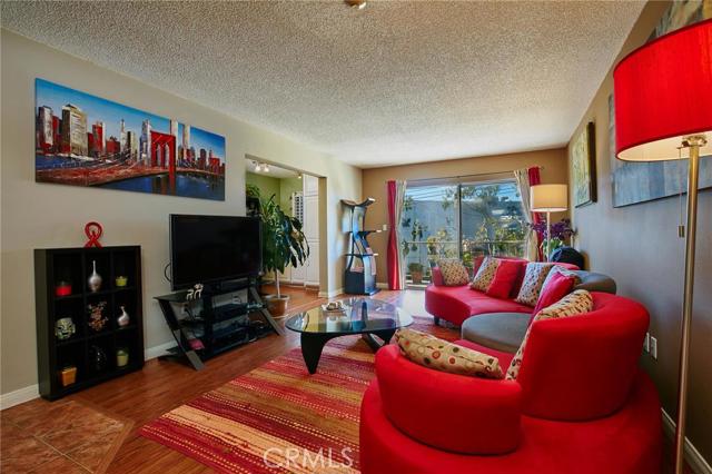 Bright living room opens up to balcony that stretches across the condo. 