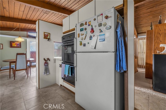 Refrigerator, double oven and view of the dining area