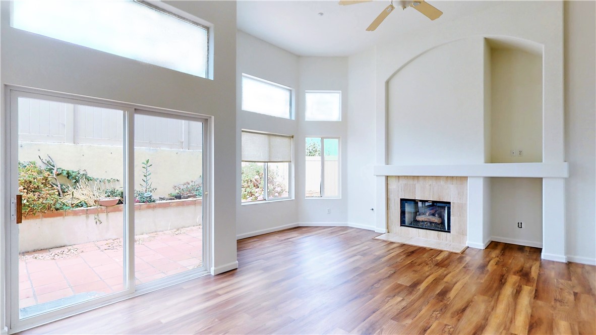 High ceilings, large windows, and fireplace in the Living Room