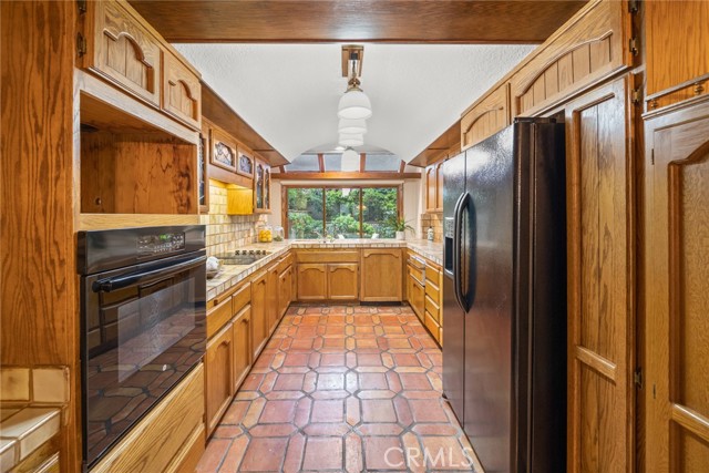 Galley kitchen opens to family room
