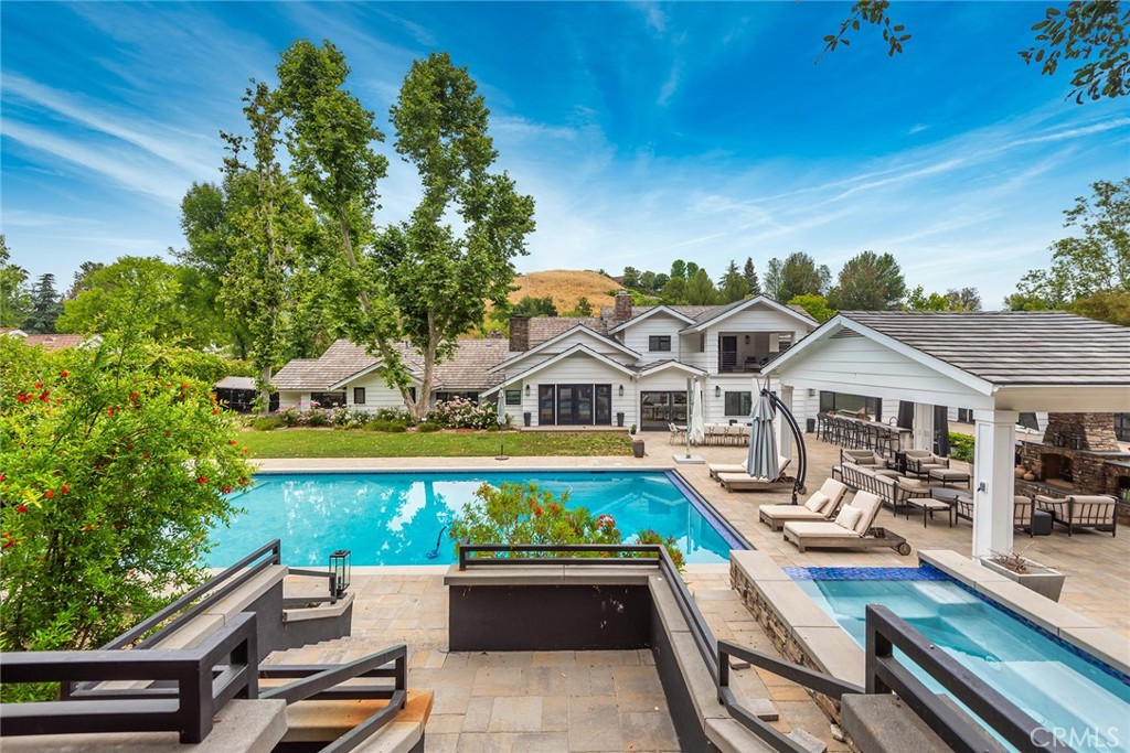 This beautifully remodeled and nicely upgraded Cape Cod Estate is nestled on a very private 1.3 acre lot, surrounded by mature fruit & shade trees and sited on a prime double cul-de-sac. Highlights include a gorgeous, newer gourmet kitchen with stainless steel Viking & Sub-Zero appliances, stone counters & wood floors, plus an adjoining, sunny breakfast room, all wide open to the oversize family room with fireplace. Additional features include formal living & dining rooms, a true wine cellar, and a bonus room. There are five en suite bedrooms in the main house, all with newer baths, plus an additional four en suite bedrooms in the guest house! The upstairs primary suite offers a newer, all stone bath with soaking tub, oversized walk-in closet, and a private balcony overlooking the lush rear grounds. All other bedrooms are downstairs. There is also an attached, ancillary recreation structure that includes a home theater with surround sound, a second kitchen with serving counter & soda fountain, a large party room (with recently added "garage doors" that open for potential extra car storage), and two additional baths. The superbly private grounds include a large Pebble Tec pool with automatic cover and a separate 12-person spa, two covered patios, a deluxe barbecue center with stainless steel appliances & refrigerator, an outdoor fireplace, rolling lawns, circular drive with hand laid pavers, and gated off street parking. There is also a newer roof, excellent curb appeal, and so much more. The square footage shown includes the main house, guest house, and ancillary party structure as measured by an appraiser.
