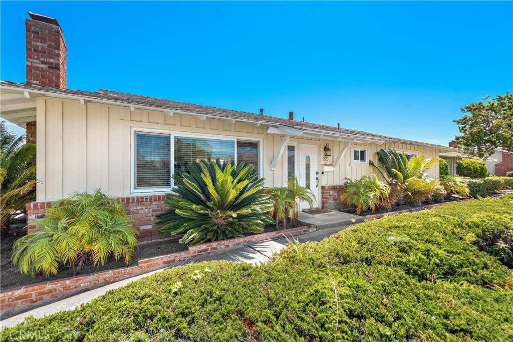 Live the beach-close lifestyle you desire at this impeccably upgraded single-level ranch-style home in San Clemente. Located in the highly sought-after 55-and-better community of Bay Cliff Village, the two-bedroom, two-bath residence lives like a single-family design, with only one wall shared with its neighbor. Meticulously maintained landscaping, used brick and board-and-batten siding reflect the home’s 1962 heritage, while the interior, which measures approximately 1,266 square feet, showcases today’s popular design elements. A custom entry door opens to a light and open floorplan featuring a living room with a custom fireplace, a dining room with sliding-door access to the patio, and a remodeled kitchen with Shaker cabinetry, quartz countertops, a full tile backsplash, a pantry, French-door refrigerator, and a suite of stainless steel Bosch appliances including an oven, microwave, dishwasher and a five-burner cooktop. A quartz countertop and frameless glass shower enclosure enrich the guest bath, and the primary suite boasts a large closet, and an ensuite bath with granite countertop, a walk-in shower and slate tile surrounds. Woodgrain luxury tile flooring, plush carpet, custom paint, upgraded windows, Shaker-style interior doors, recessed lighting, a laundry closet with full-size washer and dryer, newer HVAC, water filtration system and a tankless water heater lend style and energy-efficiency throughout. Custom Trex composite decking and newer concrete embellish the private patio, which features direct access to a one-car garage with built-in storage—an extremely rare advantage in the neighborhood. Bay Cliff Village is limited to just 28 homes and offers a clubhouse for festive social gatherings, meandering pathways, and beautiful central park areas. The beach, shopping, Shorecliffs Golf Club and San Gorgonio Park are enviably close. Furnishings may be purchased out side of escrow for an additional fee.