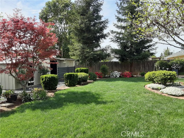 There are two storage units on the gravel in back.