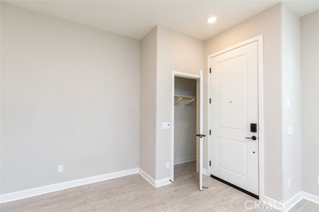View of coat closet and front door from staircase
