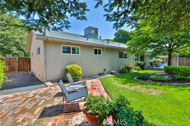 This side yard is opposite from the garage side. You can see the HVAC on the roof, and a water heater door in back of house.
