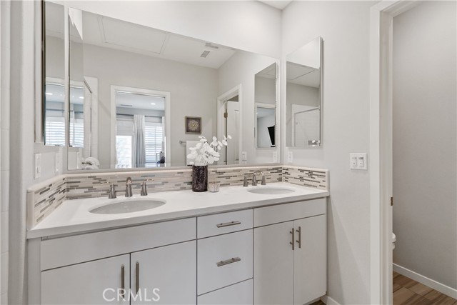 Ample space in the primary bathroom with dual vanities.