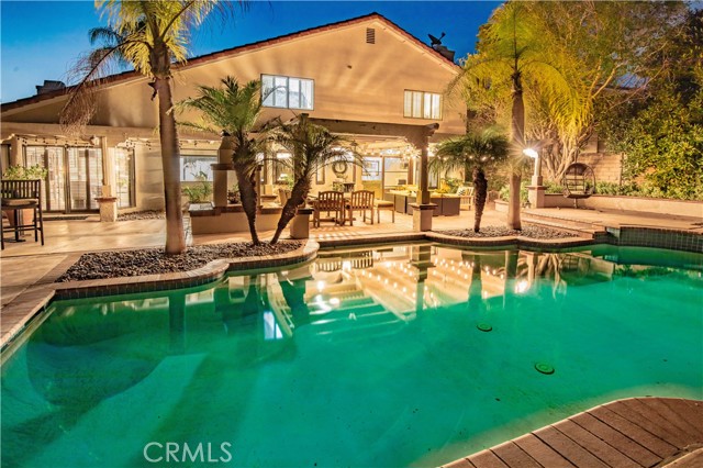 Private resort-style backyard with pool, spa, fire pit and grassy area.