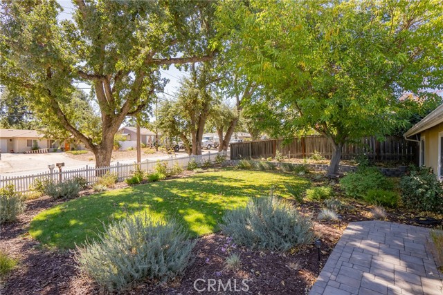 Idyllic front yard complete with a quaint white picket fence!  The low maintenance landscaping was recently added.