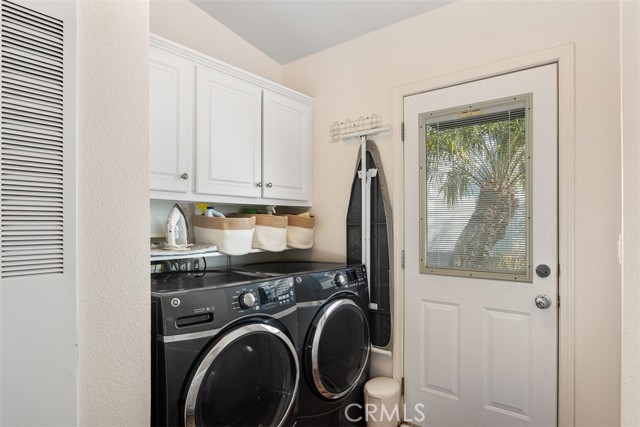 Spacious Laundry room with door leading out to side yard