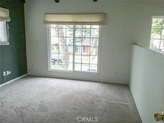 This is the loft when entry showing window overlooking the front patio.