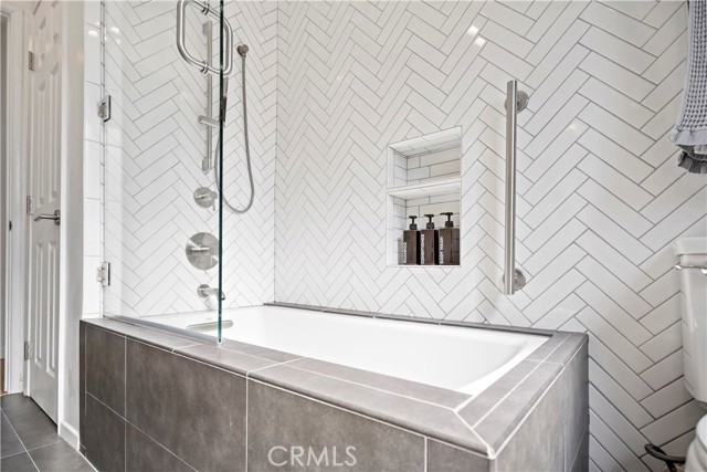 Herringbone tile and bathtub