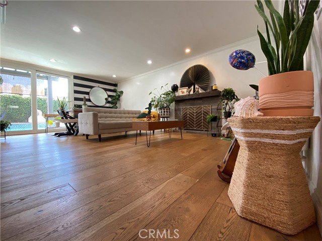 Expanded family room features wood burning fireplace