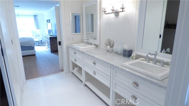 Primary en-suite bathroom with double sink vanity.