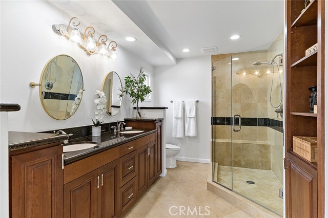 Custom bath with dual sink vanities and walk-in shower